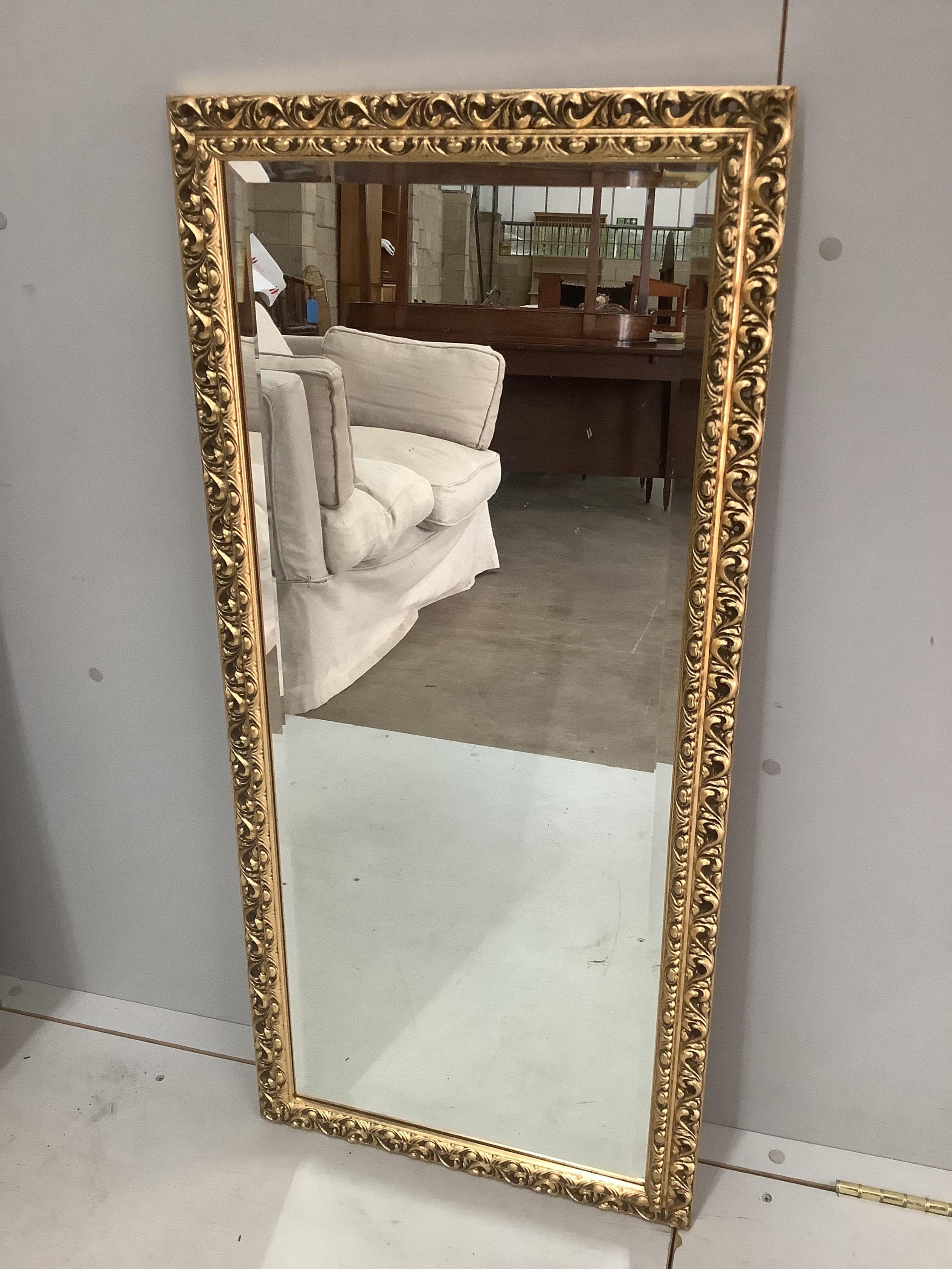 An 18th century style gilt composition wall mirror, width 54cm, height 100cm together with a reproduction Victorian style wall mirror. Condition - fair